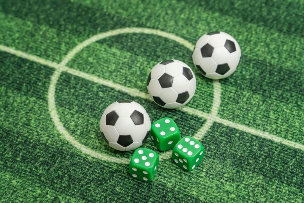 dice and mini footballs in field