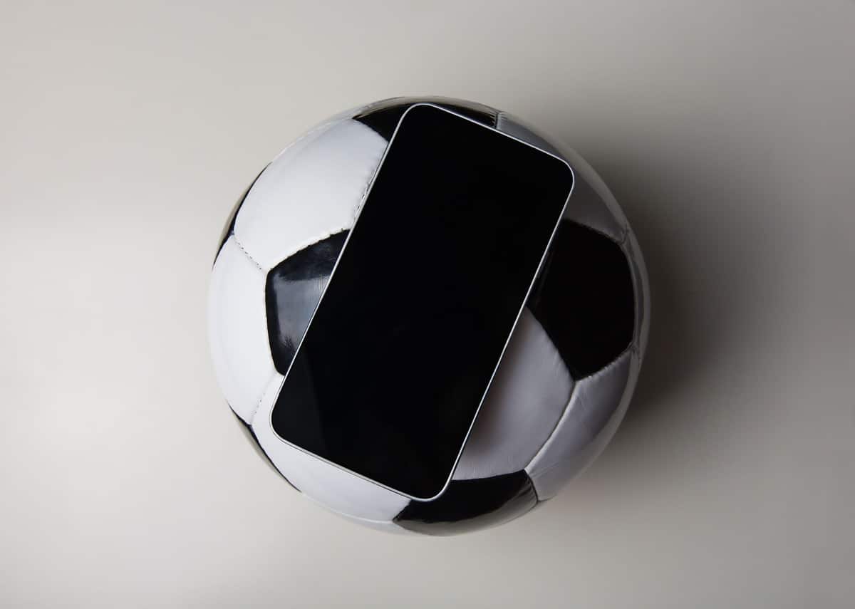 black and white image of phone and a football