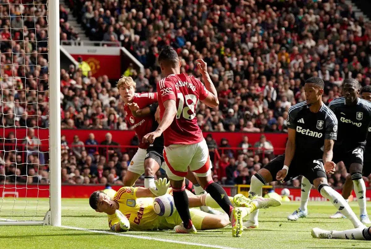 Aston Villa's Emiliano Martinez saves at the feet of Casemiro of Manchester United, 2025