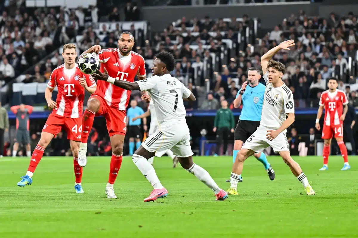 Tackle between Jonathan Tah (Bayern Munich) and Vinicius Junior (Real Madrid) during the UEFA Champions League match between Real Madrid and FC Bayern Munich, 7 April 2026